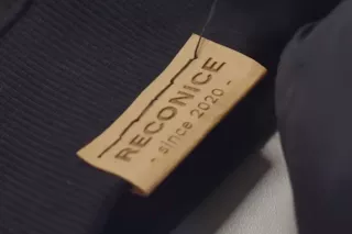Der Schriftzug des Label „Reconice" an einem Pullover.